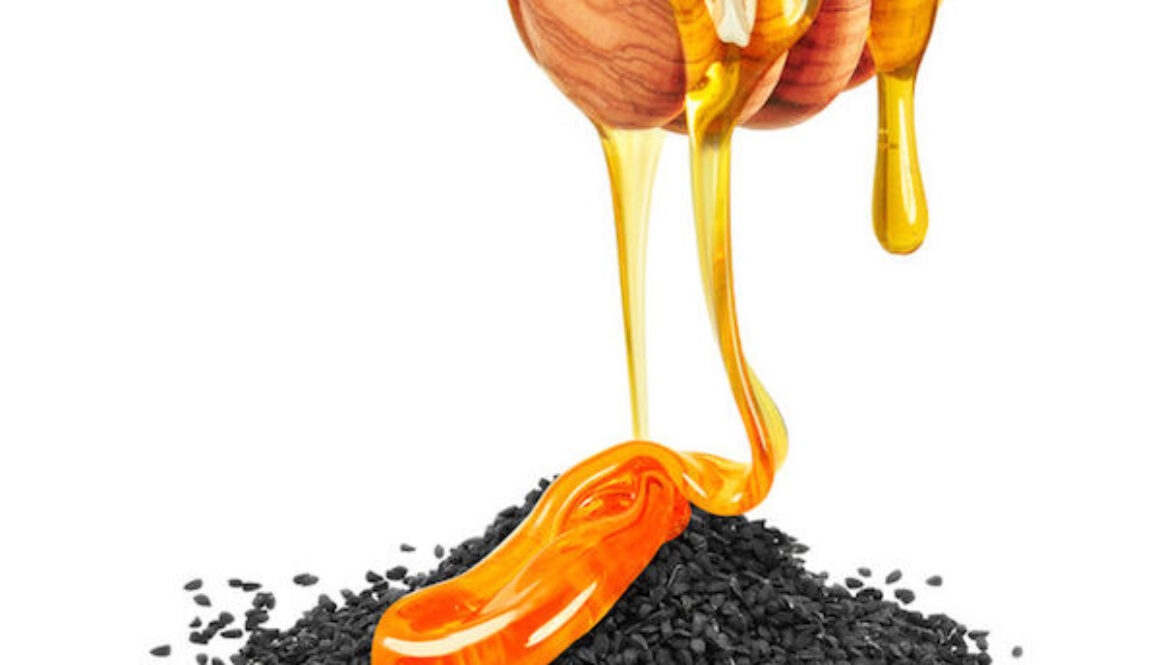50795738 - black cumin with honey isolated on a white background
