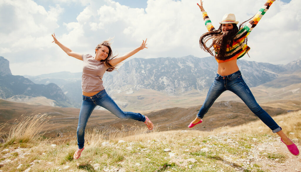 Happy Women Travel And Jump Together