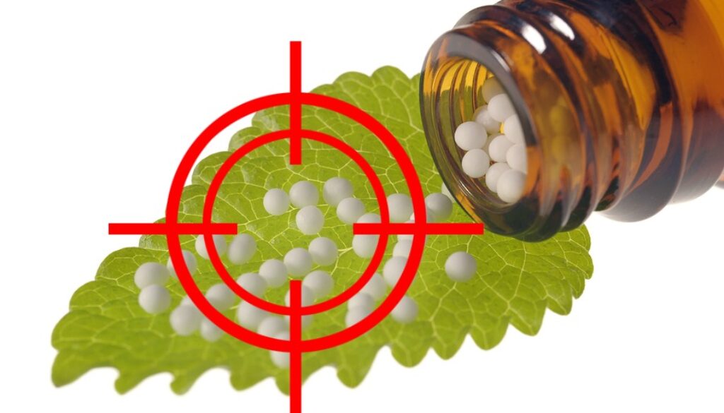 alternative medicine and homeopathy with herbal globules on leaf
