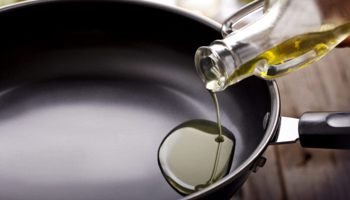 Pouring eating oil in frying pan